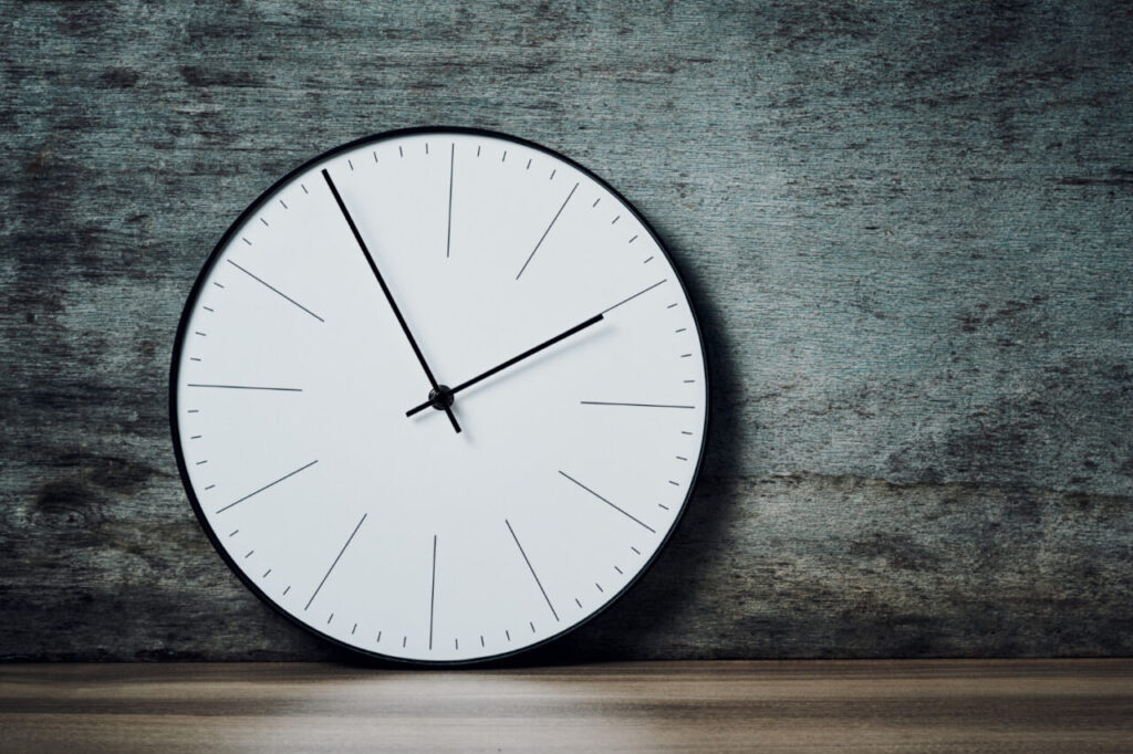 Horloge murale design fixée sur un mur en béton, soulignant le minimalisme élégant et la modernité de la décoration intérieure